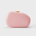 Pink pebble-shaped PU leather clutch bag with golden metal spherical clasp on white background - Pink