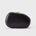 Minimalist black pebble shaped leather clutch with golden dome clasp on studio background - Black