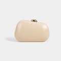 Close-up of cream pebble-shaped clutch bag with elegant gold hemispherical metal clasp - Apricot