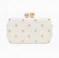 Detail view of white evening clutch bag featuring gold studs and large ball clasp closure - Oval Shape (Gold Studs) / Milky White