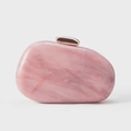 Detail of pink marble acrylic shell clutch with sleek rose gold metal clasp for evening - Pink