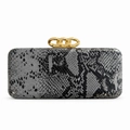 Close-up of snakeskin textured evening clutch with decorative gold chain link clasps - Gray
