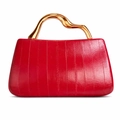 Detail of red patent leather handbag with vertical stitching and wavy gold metal handle - Red