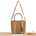 Handwoven straw tote bag in light brown with leather strap and decorative tassel - Camel