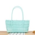 Hollow out woven tote bag in mint blue plastic with long handles on a wooden table - Tiffany Blue (Rectangular)
