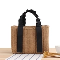 Minimalist beige woven straw tote bag with black pleated ribbon handle for beach travel - Camel