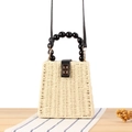 Beige geweven stro handtas met zwart kralen handvat en gouden metalen sluiting - Beige