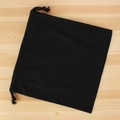 Flat lay of a square black canvas drawstring organizer bag on a light wood surface - 30cm*30cm / Black