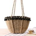 Natural straw beach tote with decorative black pom-pom trim and braided handles - Camel