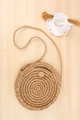 Handmade round straw shoulder bag in natural khaki with intricate spiral woven texture - Camel