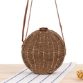 Round brown woven straw crossbody bag with leather strap and decorative white stitching - Dark Brown