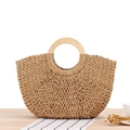 Minimalist straw woven handbag with round wooden handles on a rustic table setting - Camel