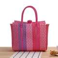 Colorful woven plastic beach bag in vibrant magenta with blue and orange stripes - Rose Red