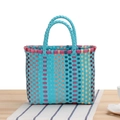 Cyan woven picnic basket with pink and blue stripes on a wooden table setting - Lake Blue
