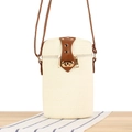 Fashionable paper rope woven cylindrical bag in off-white with brown leather strap - White