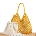 Handwoven yellow tote bag with cream drawstring liner on a natural wooden desk - Yellow with White Liner