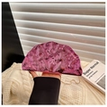 Detail of pink metallic evening clutch with wavy texture and gold chain strap - Pink