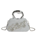 Macro detail of silver clutch featuring intricate floral rhinestone inlay and sequins - Silver