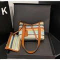 Macro shot of colorful striped woven shoulder bag with faux leather strap in a gift box - Brown Rainbow