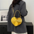 Glossy gold heart-shaped crossbody bag with top handle and metallic leather texture - Bright Gold
