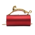 Macro shot of red cylindrical acrylic evening bag with a gold leopard handle and chain - Red