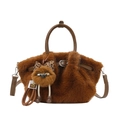 Detail of plush brown bag with round handle, faux fur texture and cute doll charm - Brown