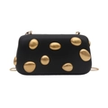 Close-up of black matte evening clutch bag featuring decorative gold metal pebble details - Black