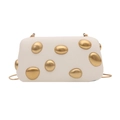 Close-up of white hard-shell evening bag with gold pebble-textured metallic accents - White