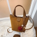 Bolso cubo de gamuza mostaza con colgante de felpa y correa de hombro ajustable - Marrón con colgante