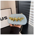 Detail of light blue leather clutch featuring a wavy gold metal accent and chain strap - Light Blue