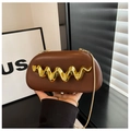 Detail of brown faux leather clutch with elegant gold wavy hardware and chain strap - Coffee