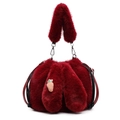 Detailed close-up of plush bucket bag with fuzzy rabbit ears and carrot embroidery - Burgundy