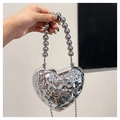 Detailed view of silver heart-shaped evening bag with textured finish and beaded handle - With Handle Style / Silver