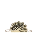 Macro detail of golden shell-shaped clutch featuring radial texture and fine metal chain - Light gold