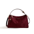 Detail of burgundy suede tote with diamond quilting, gold zipper, and adjustable strap - Burgundy