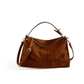 Close-up of brown suede bag with quilted diamond pattern and golden metal hardware details - Brown