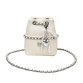 Close-up of litchi grain bucket bag featuring pearl bow charm and chain strap - Off White