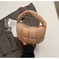 Close-up of khaki quilted puffy handbag with thick handle and silver zipper detail - Khaki