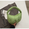 Detailed shot of green quilted cloud handbag featuring soft padded fabric and zipper - Grass Green