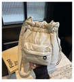 Detail of cream nylon bucket bag with drawstring closure and large front flap pocket - Off White