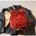 Macro detail of red nylon bucket bag showing drawstring closure and front pocket - Red