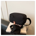 Detail of black nylon crossbody bag featuring waterproof fabric and zippered pockets - Black