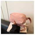 Detailed shot of pink nylon waist bag showing zip closure and adjustable woven strap - Pink