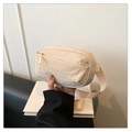 Close-up of beige lightweight nylon waist bag with smooth zipper and textured fabric - Off White