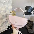 Pale pink matte leather saddle bag with gold metal twist handle and thin shoulder strap - Taro Purple