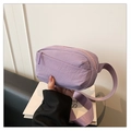 Macro detail of lavender nylon waist bag fabric and durable wide shoulder strap - Purple