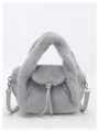 Close-up of grey fluffy faux fur handbag featuring soft plush texture and silver metal buckles - Gray