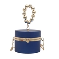 Detail of navy blue cylindrical evening bag with gold beaded handle and metal chain strap - Blue