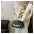 Detail of dark green acrylic evening bag featuring wavy gold hardware and a metal chain - Green