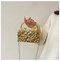 Detail of gold evening clutch with dragon handles and wrinkled metal texture - Wavy Gold